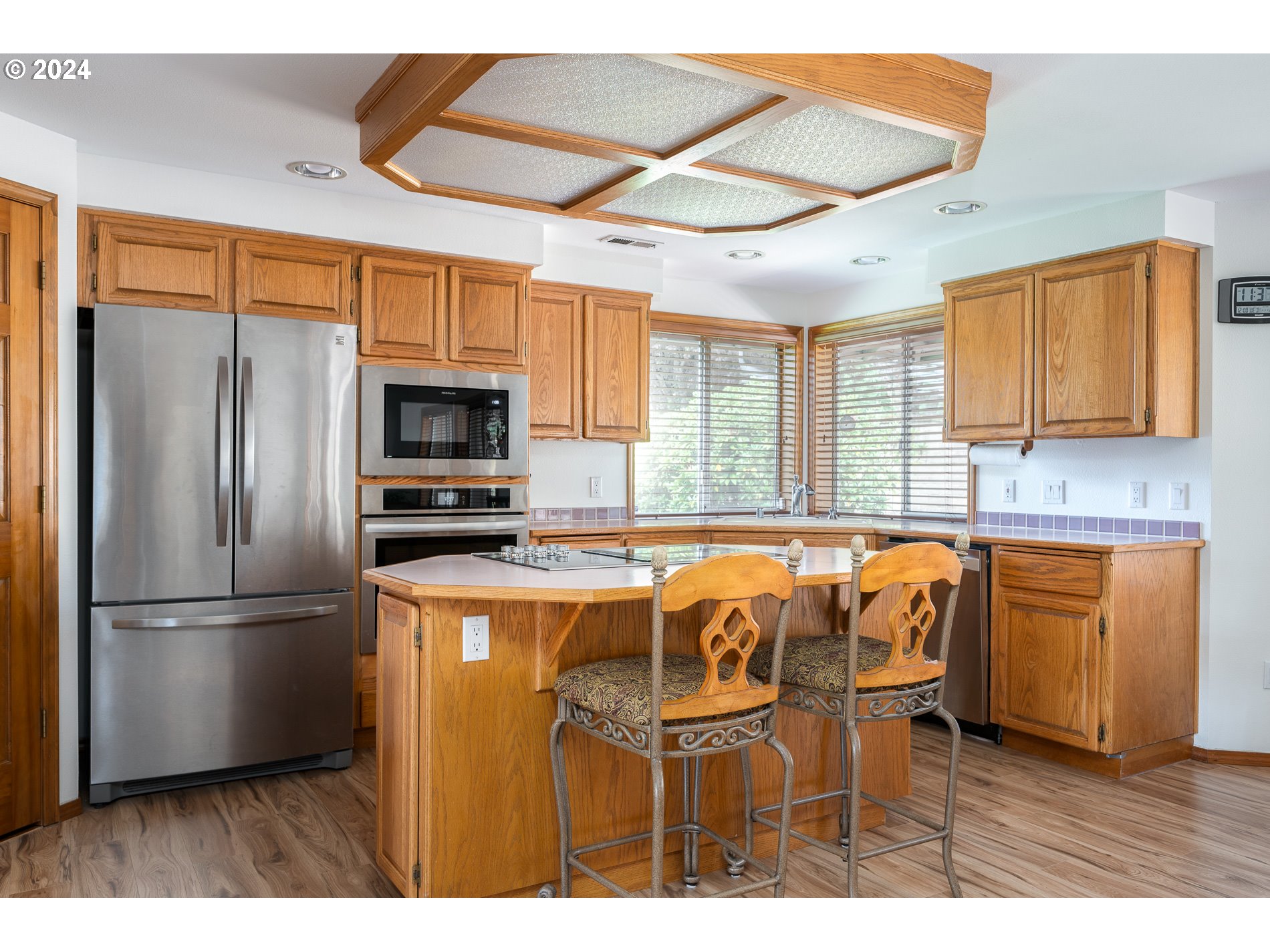 1908 Northwest 140th Circle Vancouver, WA 98685 - Photo 15 of 46 a kitchen with stainless steel appliances granite countertop a refrigerator a sink dishwasher and a stove with wooden floor