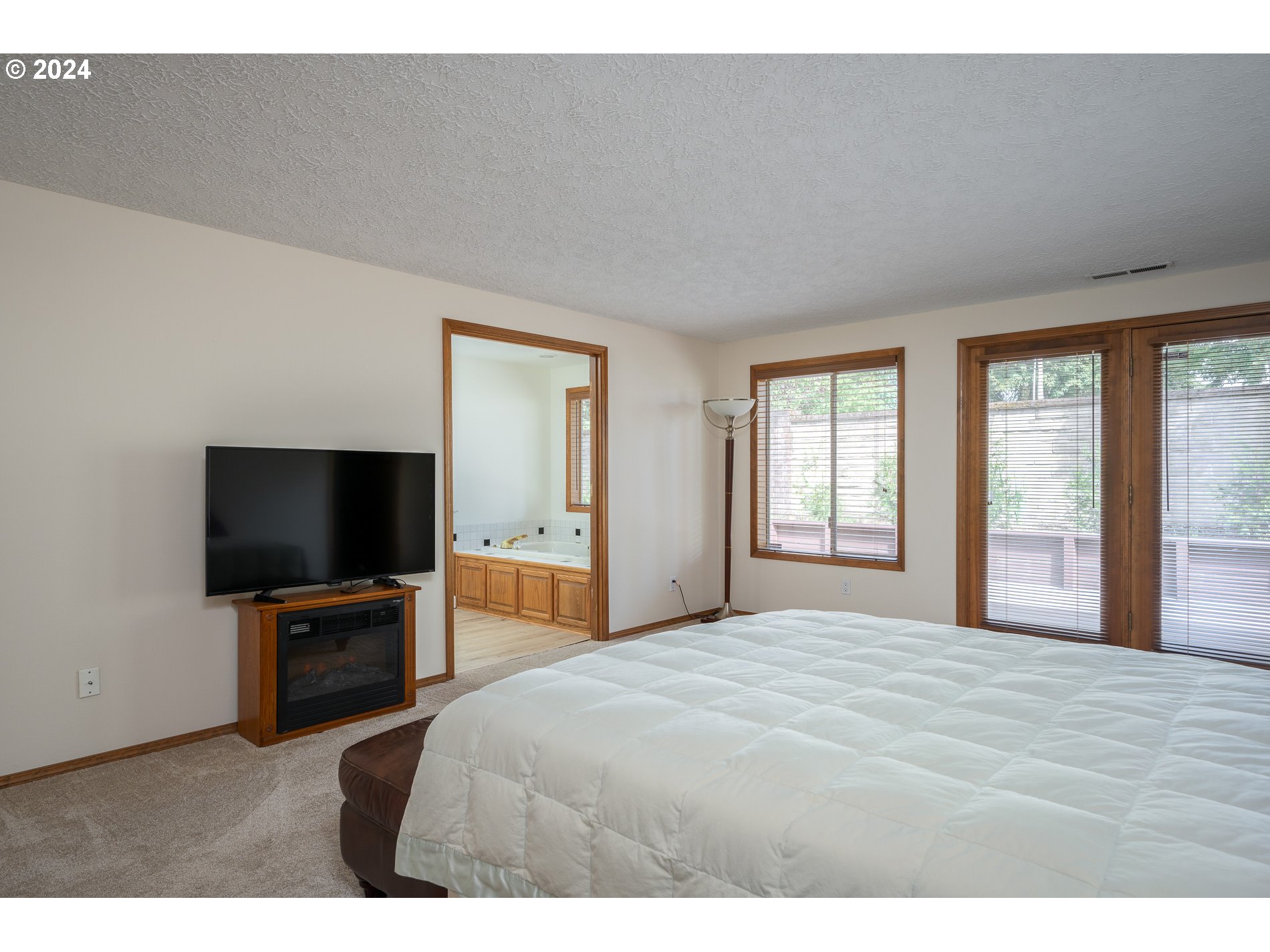 1908 Northwest 140th Circle Vancouver, WA 98685 - Photo 18 of 46 a bedroom with a bed and a flat screen tv