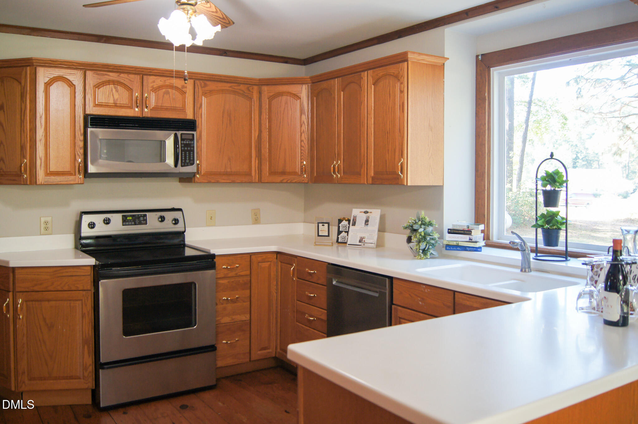 8720 Mt Pleasant Church Road Willow Spring, NC 27592 - Photo 13 of 77 a kitchen with stainless steel appliances granite countertop a stove a sink and a microwave
