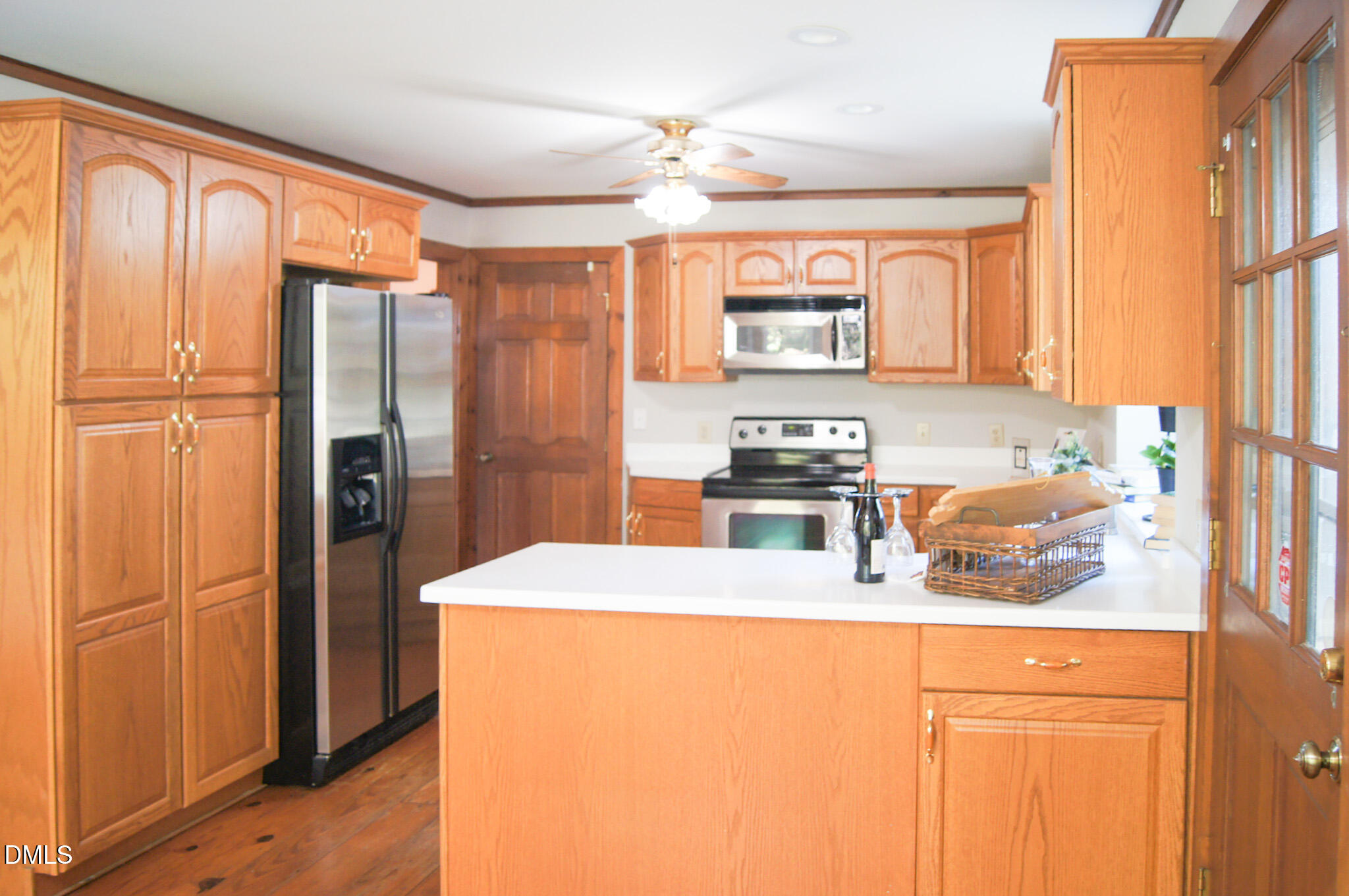 8720 Mt Pleasant Church Road Willow Spring, NC 27592 - Photo 15 of 77 a kitchen with stainless steel appliances a refrigerator and a window