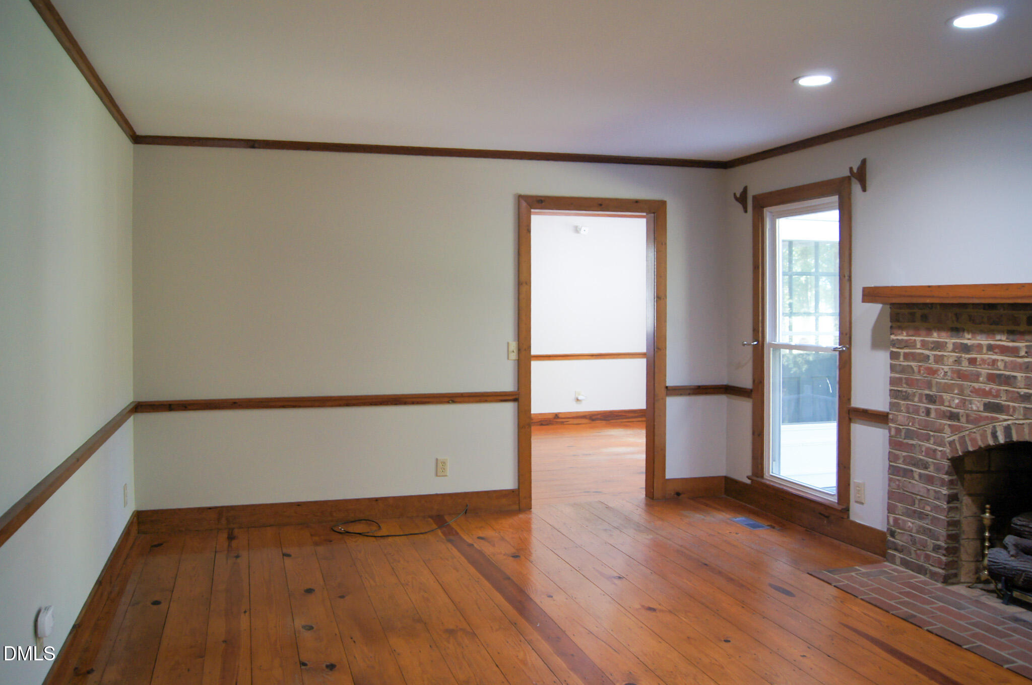 8720 Mt Pleasant Church Road Willow Spring, NC 27592 - Photo 18 of 77 a view of an empty room with wooden floor and a window