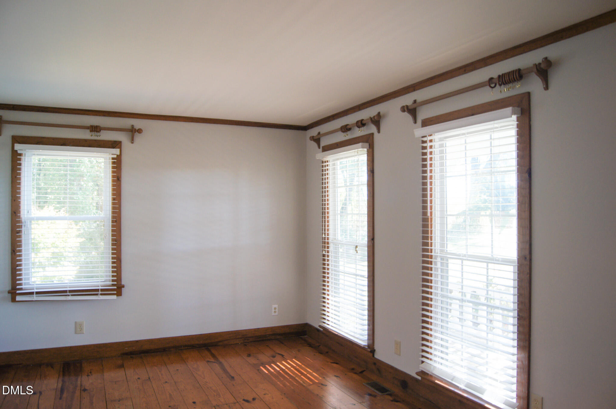 8720 Mt Pleasant Church Road Willow Spring, NC 27592 - Photo 29 of 77 a view of an empty room with wooden floor and a window