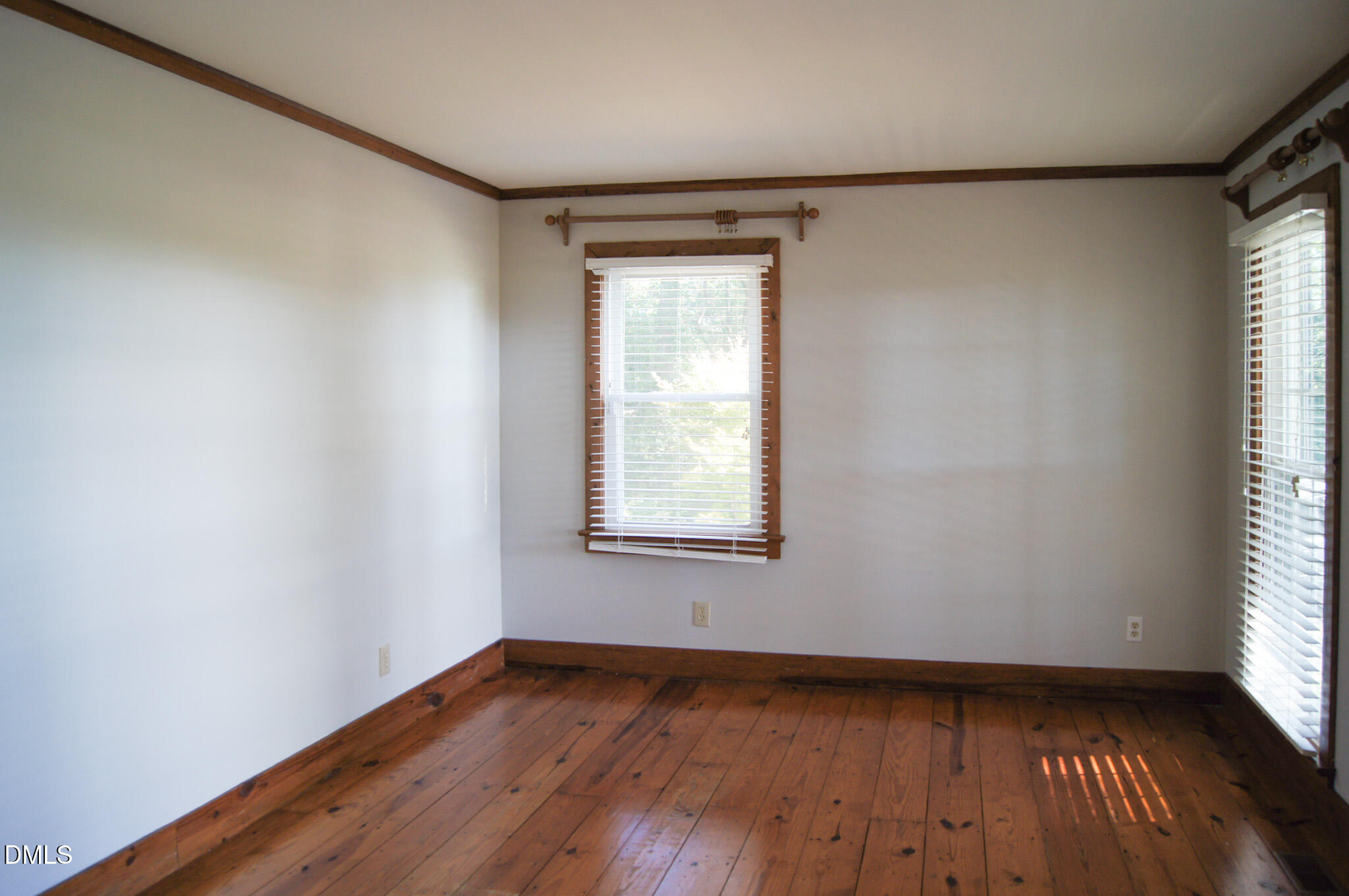 8720 Mt Pleasant Church Road Willow Spring, NC 27592 - Photo 30 of 77 a view of an empty room with wooden floor and a window