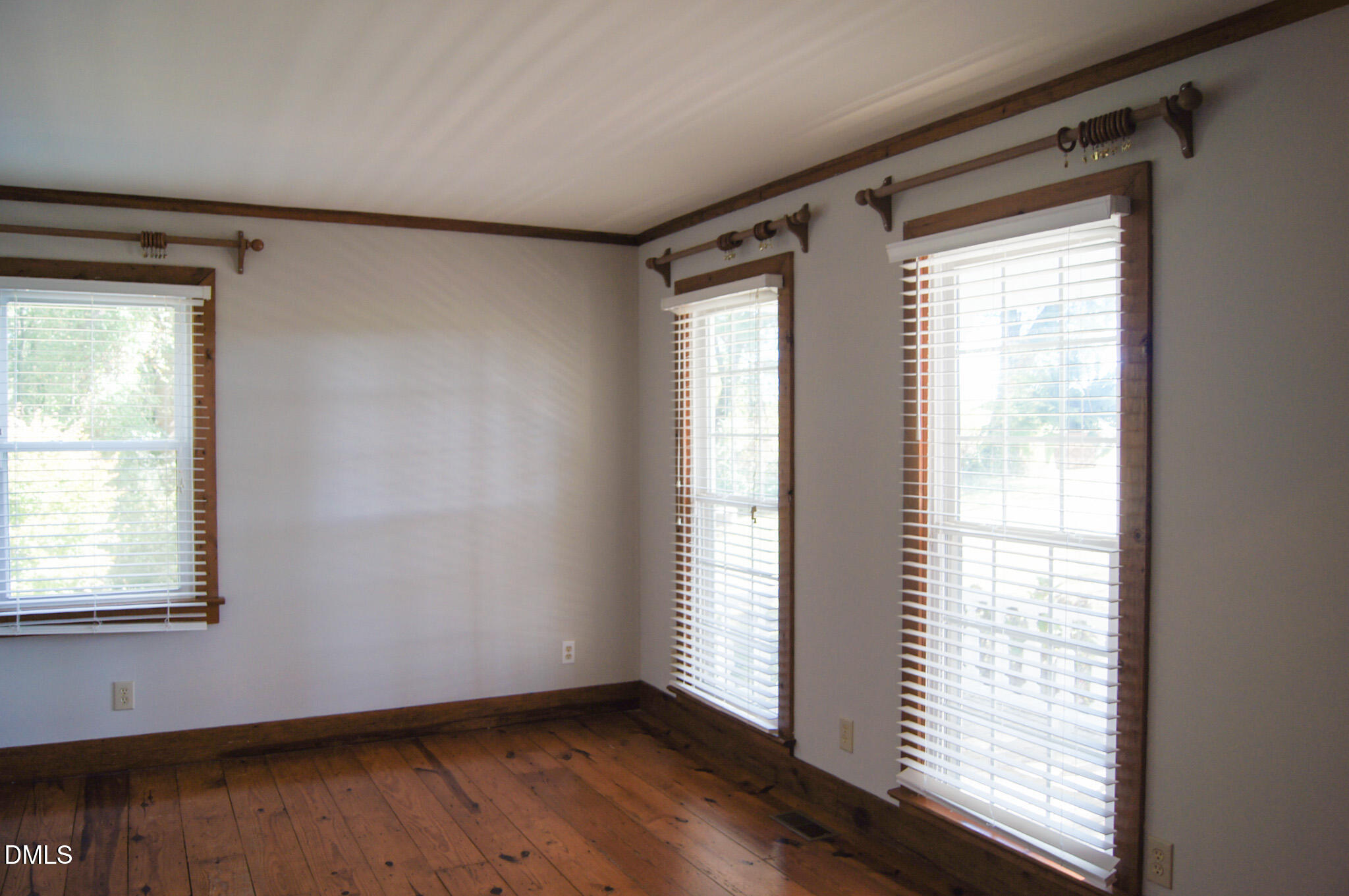 8720 Mt Pleasant Church Road Willow Spring, NC 27592 - Photo 31 of 77 a view of an empty room with wooden floor and a window