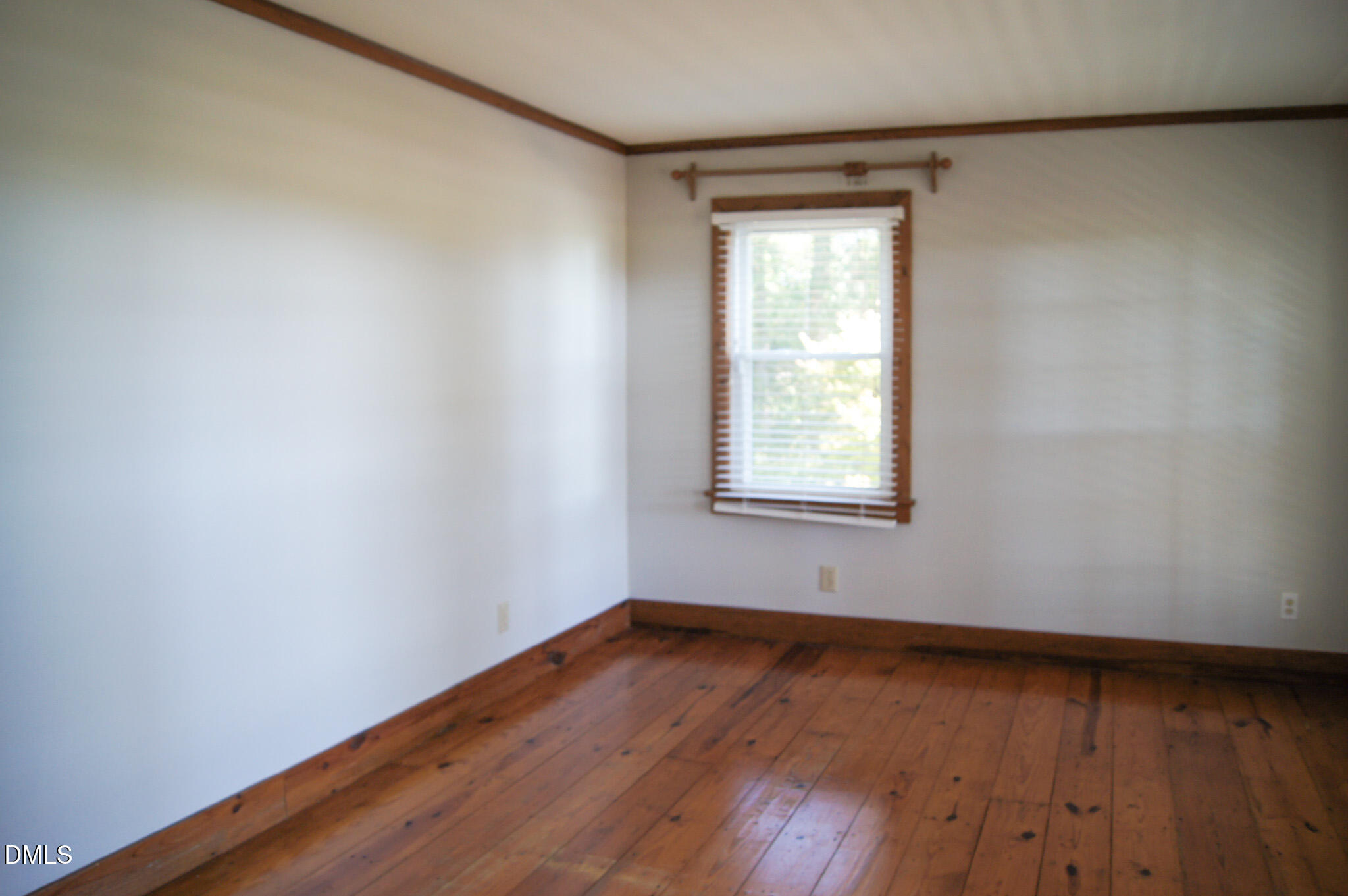 8720 Mt Pleasant Church Road Willow Spring, NC 27592 - Photo 34 of 77 an empty room with wooden floor and windows