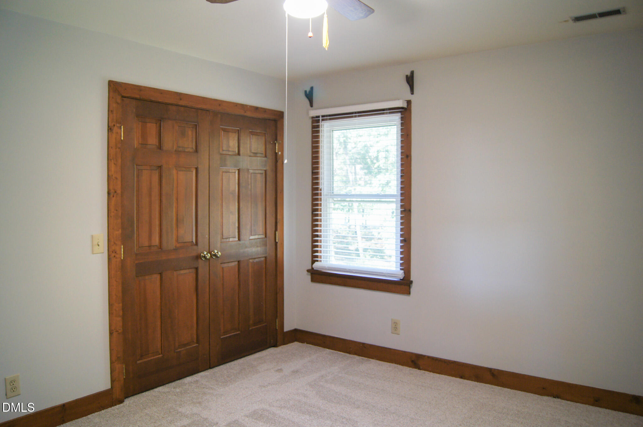 8720 Mt Pleasant Church Road Willow Spring, NC 27592 - Photo 35 of 77 an empty room with windows closet and chandelier fan