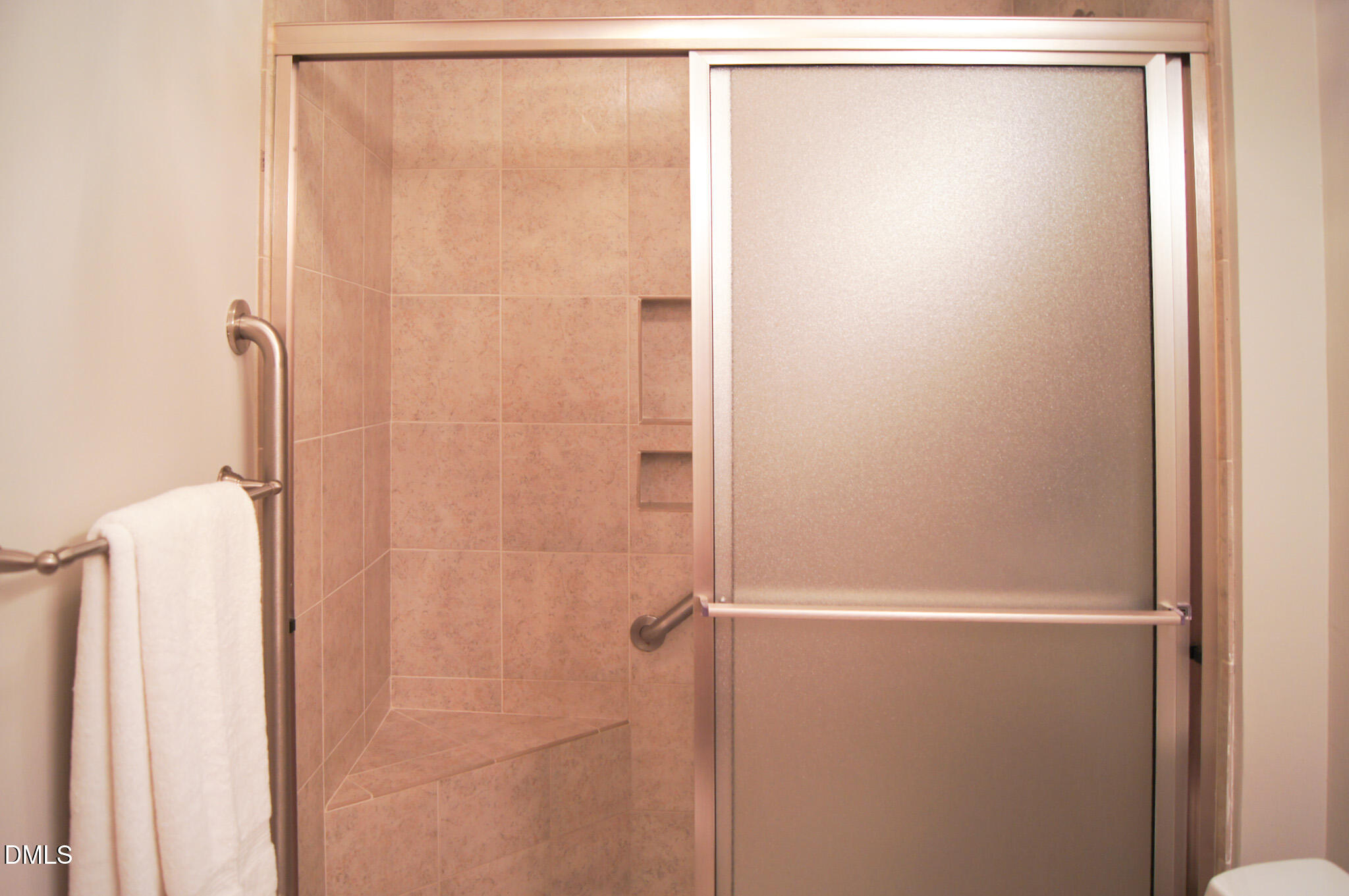 8720 Mt Pleasant Church Road Willow Spring, NC 27592 - Photo 42 of 77 a bathroom with a glass shower door