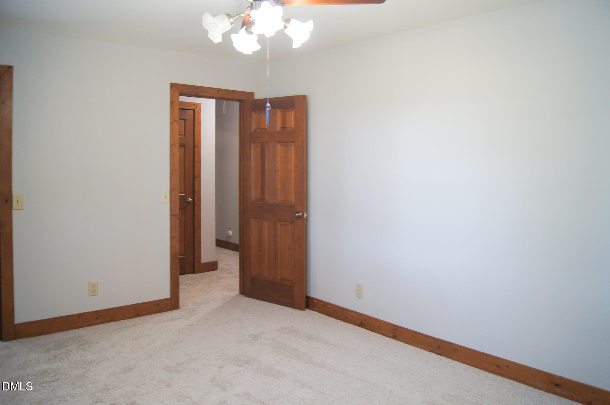 8720 Mt Pleasant Church Road Willow Spring, NC 27592 - Photo 45 of 77 an empty room with a chandelier fan