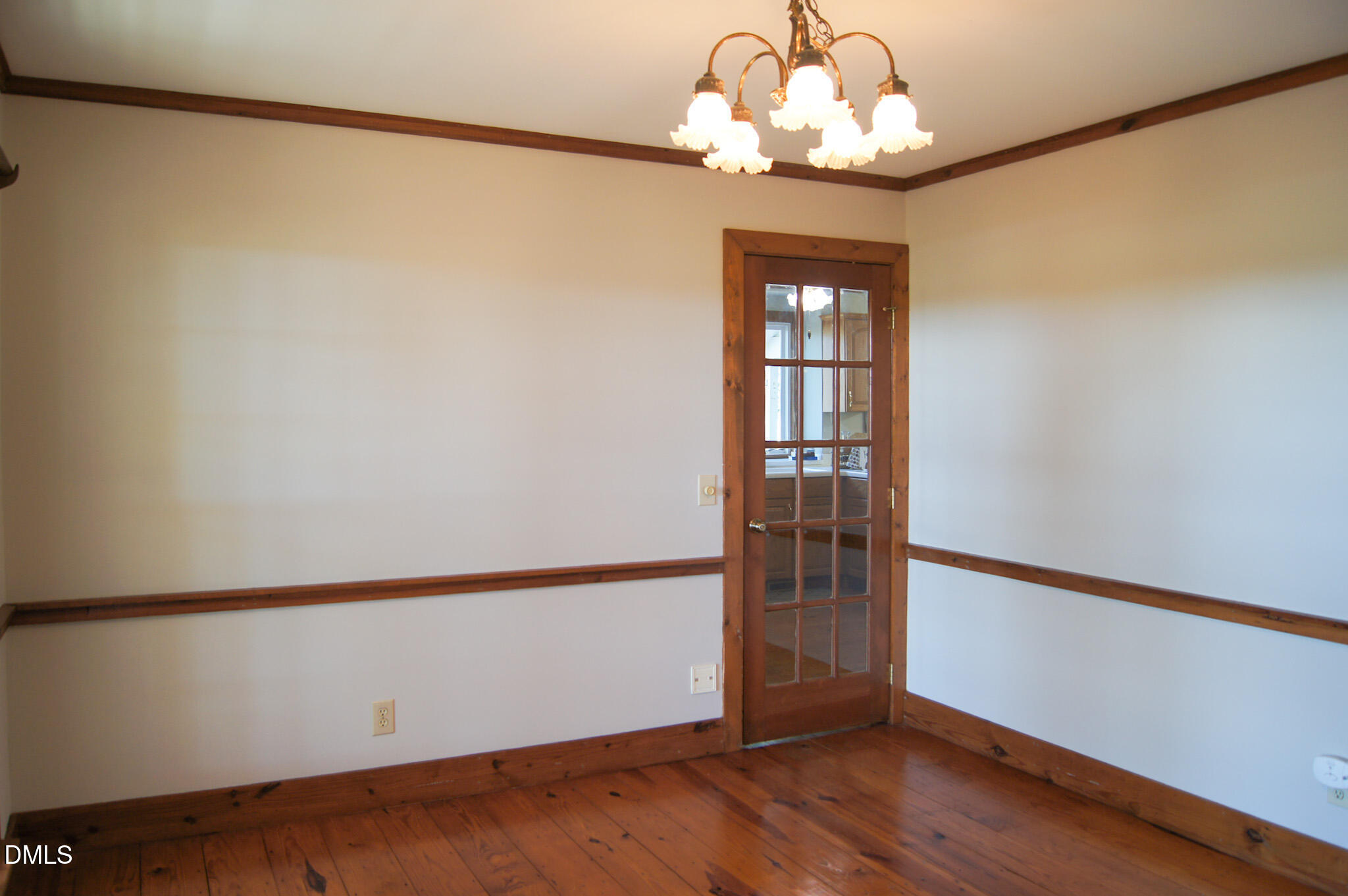 8720 Mt Pleasant Church Road Willow Spring, NC 27592 - Photo 8 of 77 a view of a room with wooden floor chandelier and a window