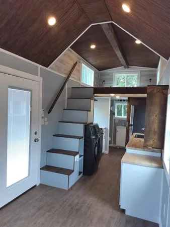 a bathroom with a sink a glass door shower and mirror