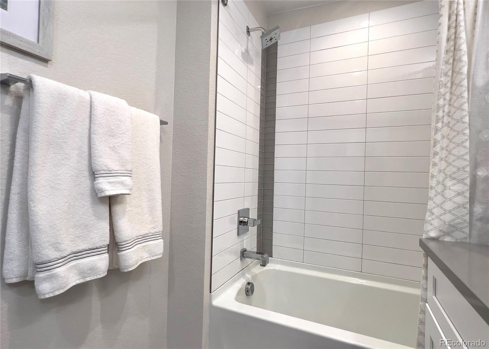 6228 West 38th Avenue Wheat Ridge, CO 80033 - Photo 22 of 38 a bathroom with a bathtub and a shower