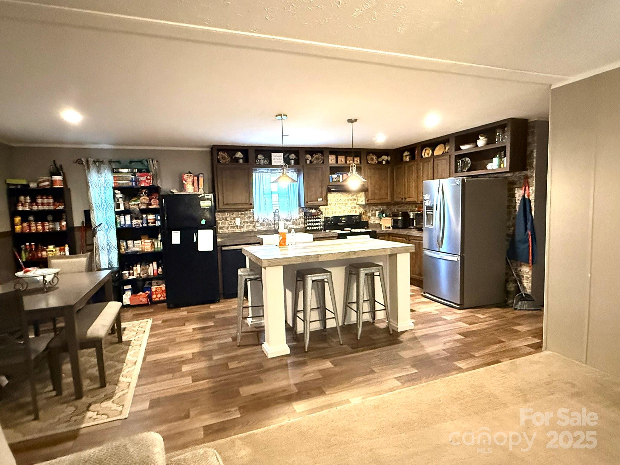2958 Sycamore Road Jefferson, SC 29718 - Photo 3 of 16 a kitchen with stainless steel appliances granite countertop a stove top oven a sink a dining table and chairs