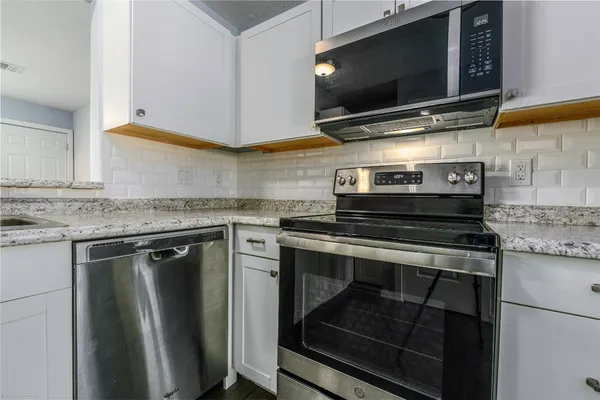 a kitchen with a stove and a microwave