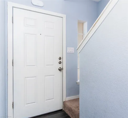 a view of a hallway with wooden floor and closet