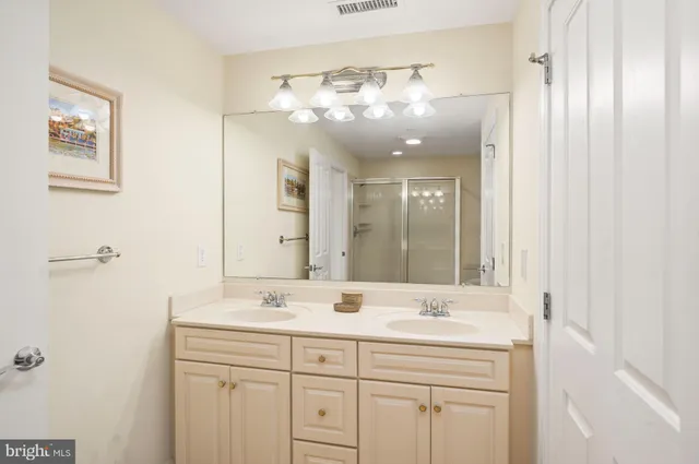 a bathroom with a double vanity sink and a mirror