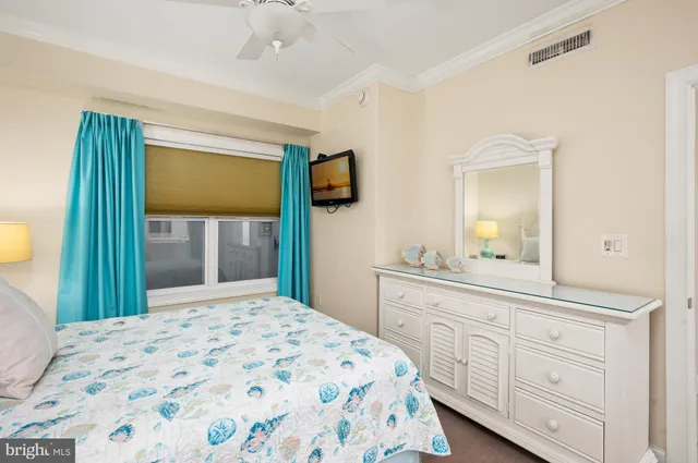 a bedroom with a bed and a large mirror