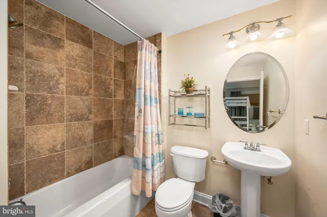 a bathroom with a toilet a sink and bathtub