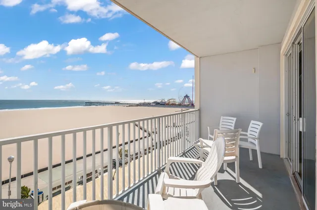 a view of a chair and tables in the balcony