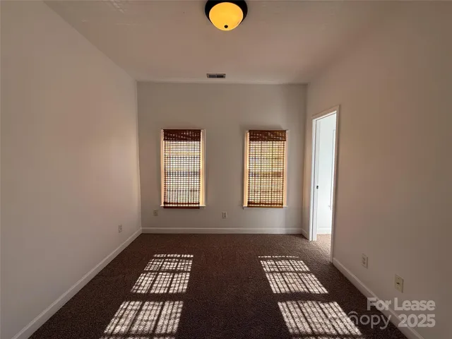 a bathroom with a granite countertop sink a light fixture and a mirror