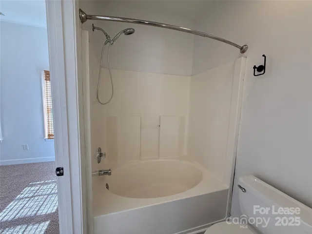 an empty room with a lamp and chandelier fan