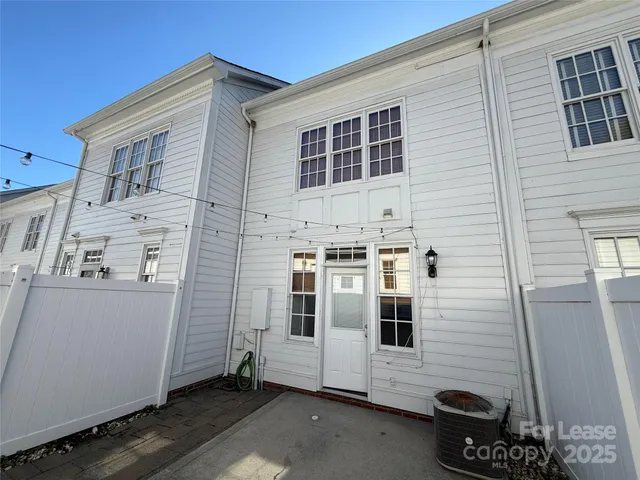 a utility room with dryer and stairs