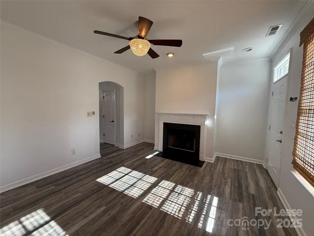 a view of empty room with wooden floor and fireplace