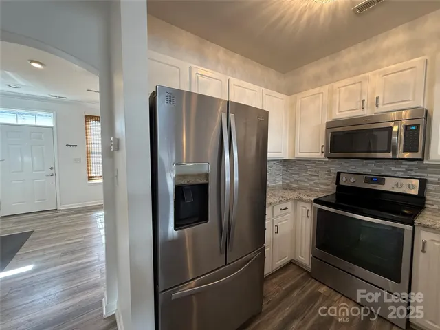 a metallic refrigerator freezer and a stove top oven