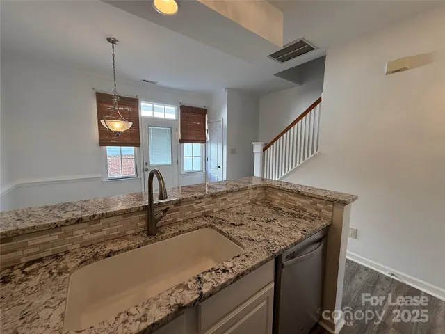 a kitchen with sink and window