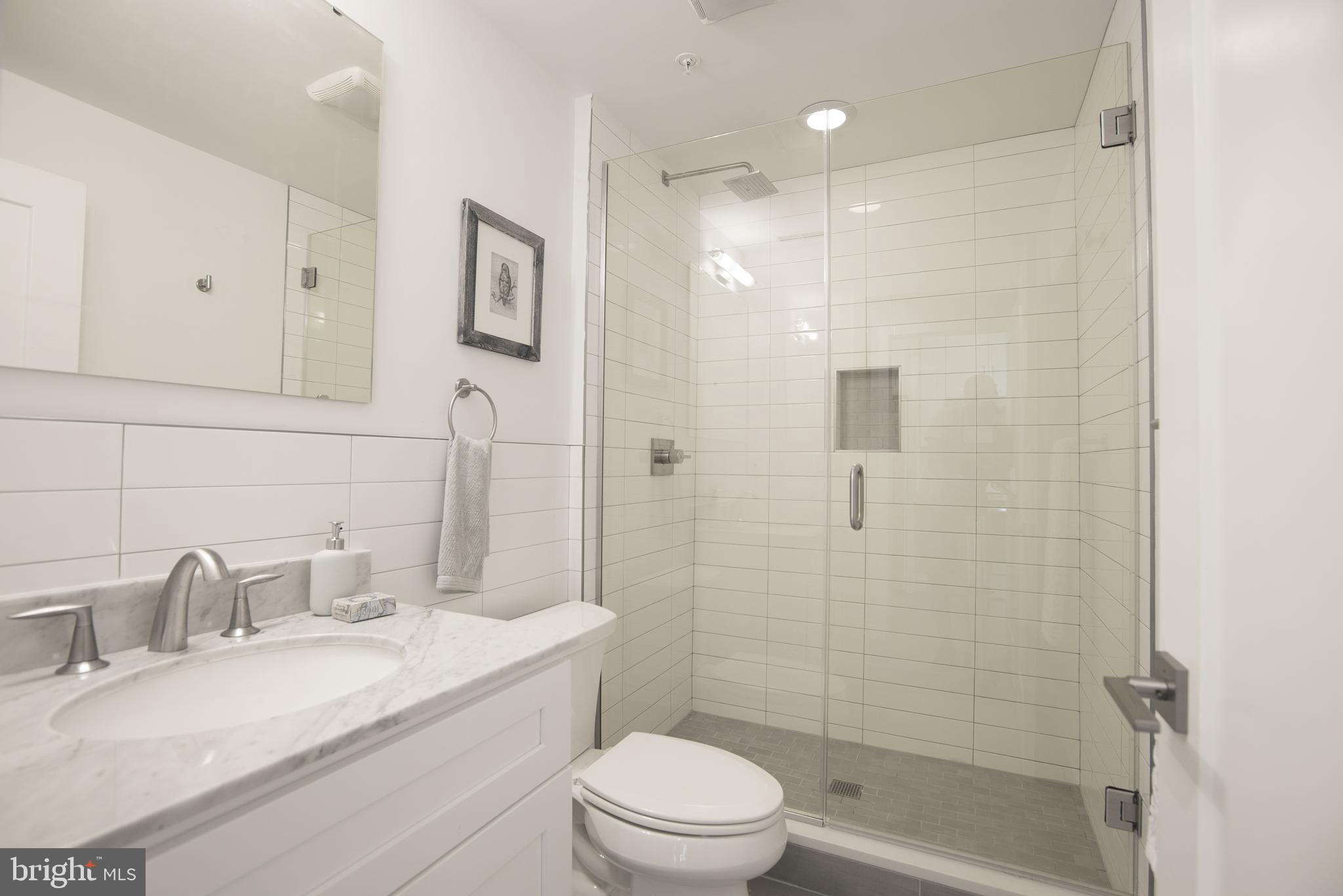 1508 Ridge Avenue, Unit 501 Philadelphia, PA 19130 - Photo 11 of 19 a bathroom with a granite countertop sink toilet and shower