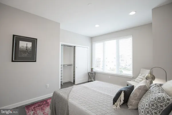 a bedroom with a bed and a window