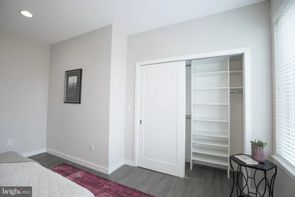 a view of a room with wooden floor and closet