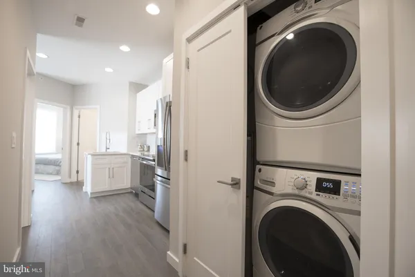 a view of a hallway with washer and dryer