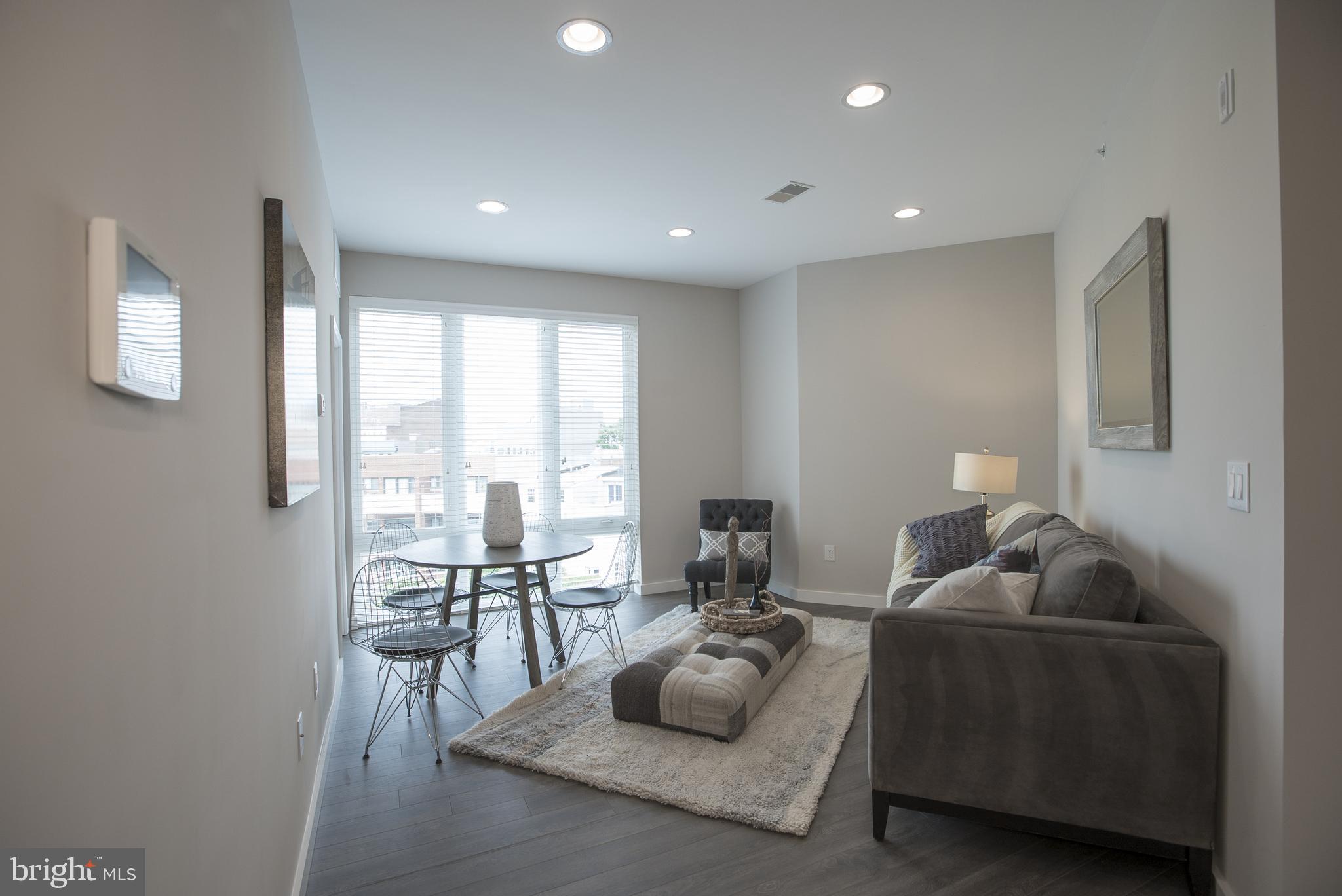 1508 Ridge Avenue, Unit 501 Philadelphia, PA 19130 - Photo 2 of 19 a living room with furniture and a large window