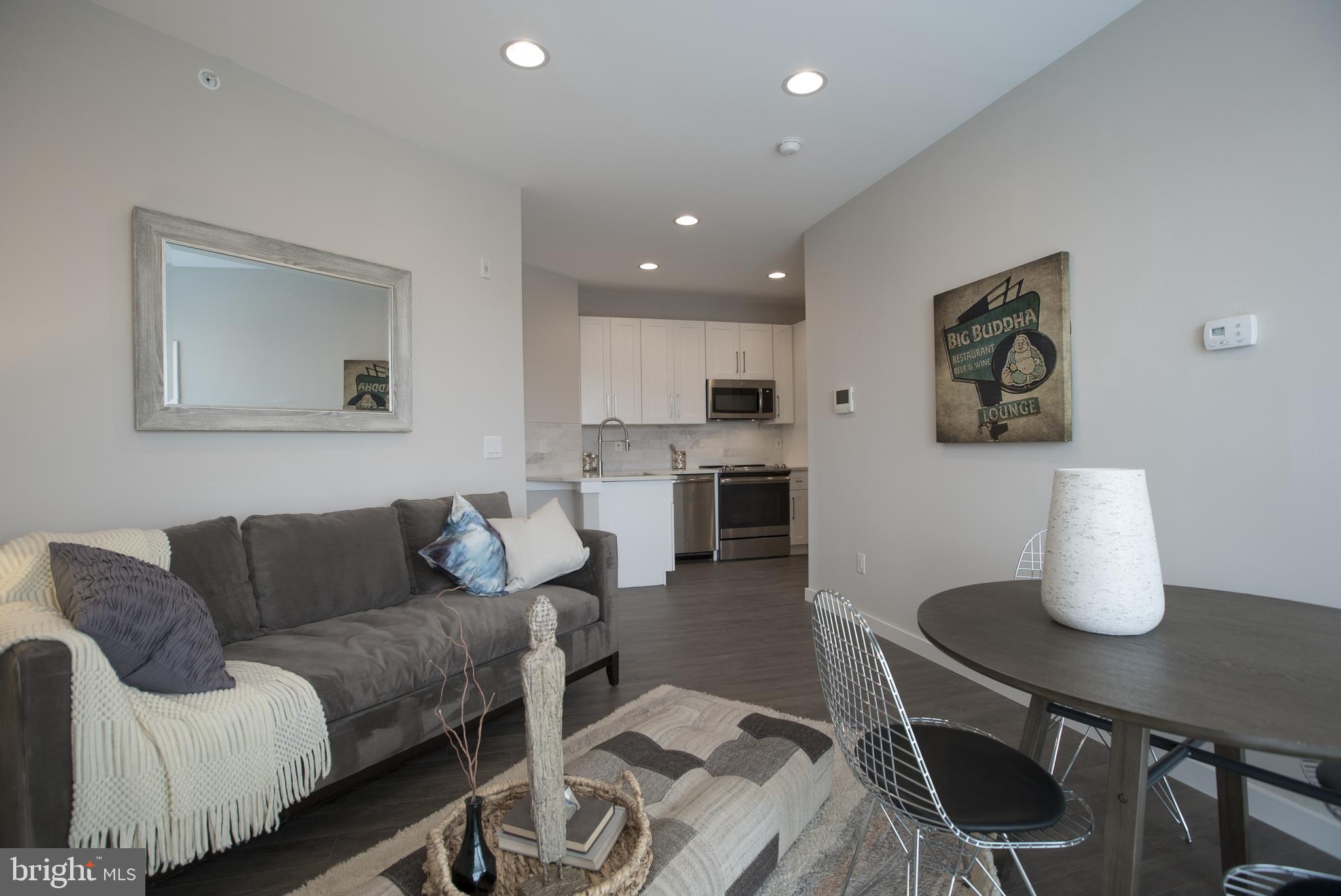 1508 Ridge Avenue, Unit 501 Philadelphia, PA 19130 - Photo 3 of 19 a living room with furniture and kitchen view