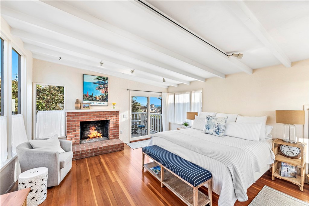 429 Hawthorne Road Laguna Beach, CA 92651 - Photo 13 of 33 a bedroom with a bed and a fireplace
