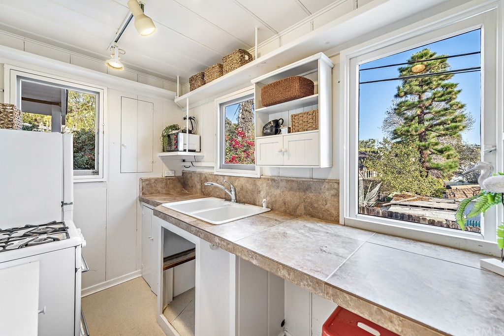 429 Hawthorne Road Laguna Beach, CA 92651 - Photo 22 of 33 a kitchen with a sink stove and refrigerator