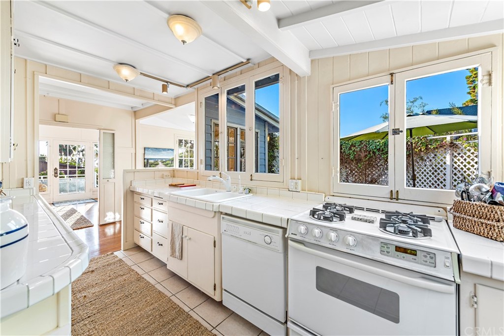 429 Hawthorne Road Laguna Beach, CA 92651 - Photo 10 of 33 a kitchen with a stove a sink and a window