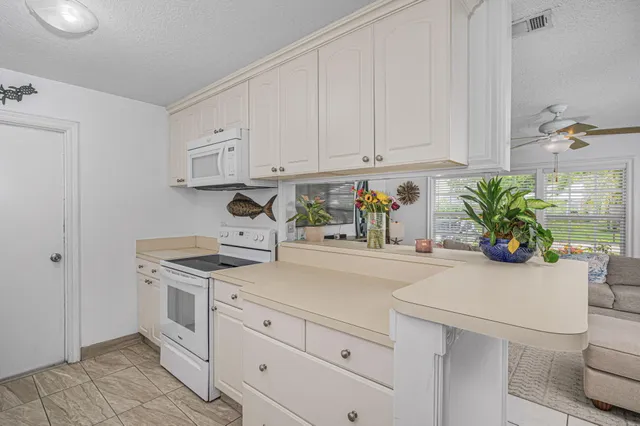a kitchen with stainless steel appliances white cabinets and a sink