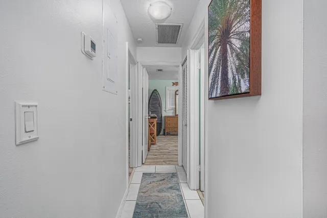 a view of a hallway with closet and a window
