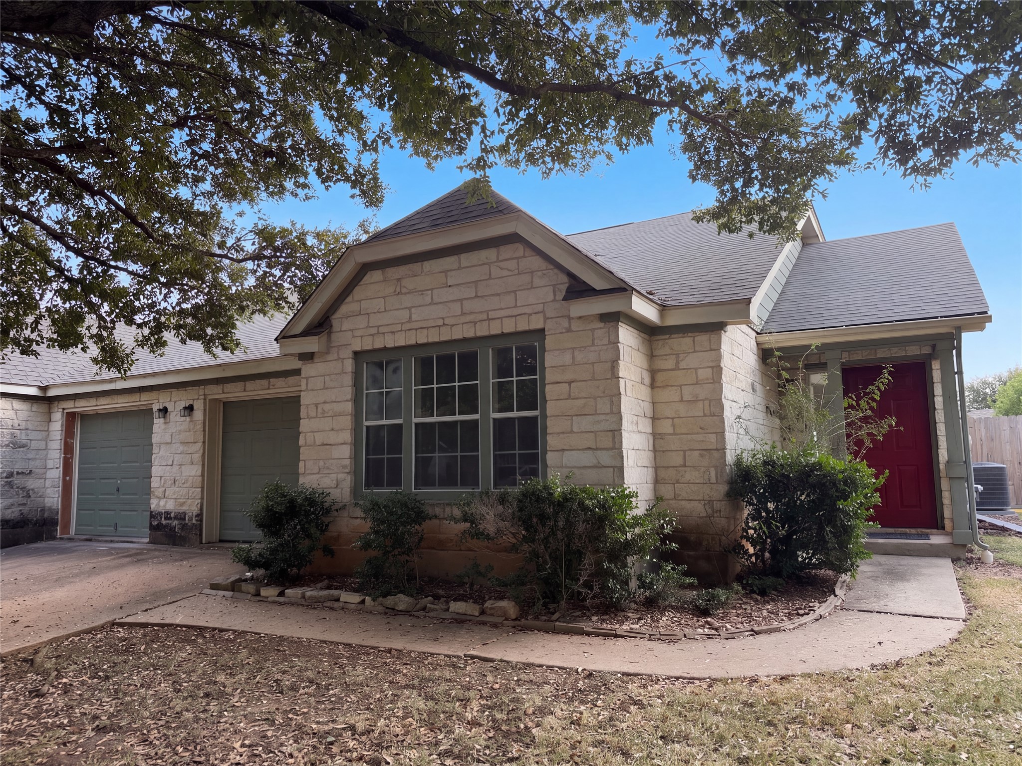 172 Prairie Springs Loop Georgetown, TX 78626 - Photo 12 of 32 Mature trees frame a charming stone facade and welcoming front pathway.