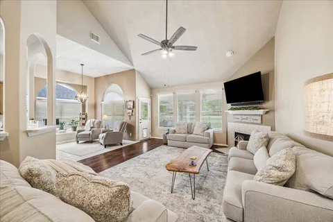 a living room with furniture fireplace and a flat screen tv