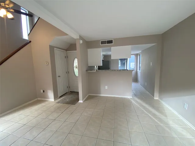 a view of a kitchen with a refrigerator and a sink
