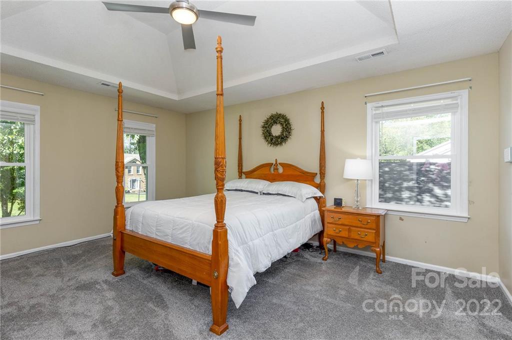 10442 Fairway Ridge Road Charlotte, NC 28277 - Photo 18 of 41 a bedroom with a bed lamp and window