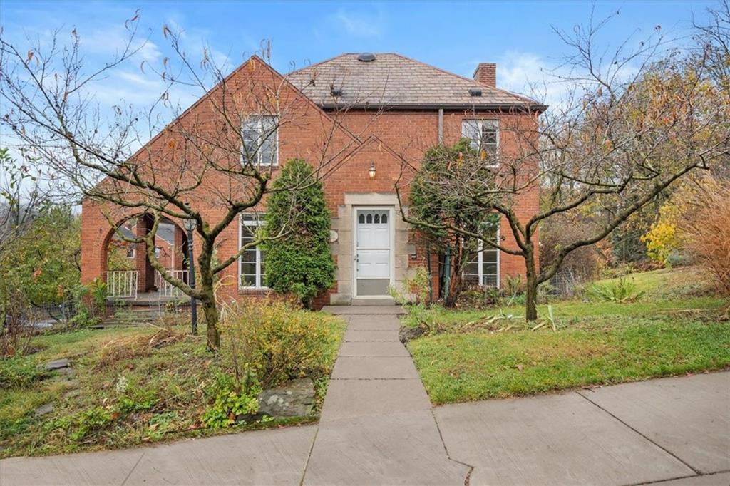 a front view of a house with garden