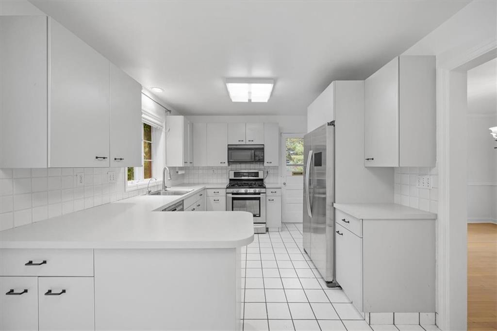 2800 Fernwald Road Pittsburgh, PA 15217 - Photo 14 of 37 a kitchen with stainless steel appliances a refrigerator sink and cabinets