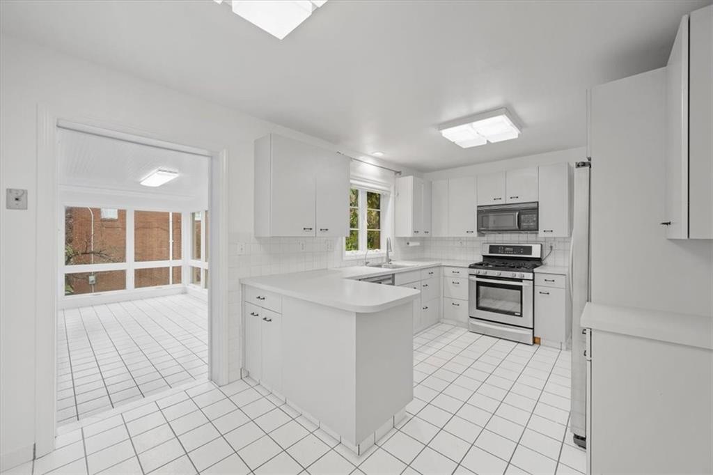 2800 Fernwald Road Pittsburgh, PA 15217 - Photo 15 of 37 a kitchen with white cabinets and appliances