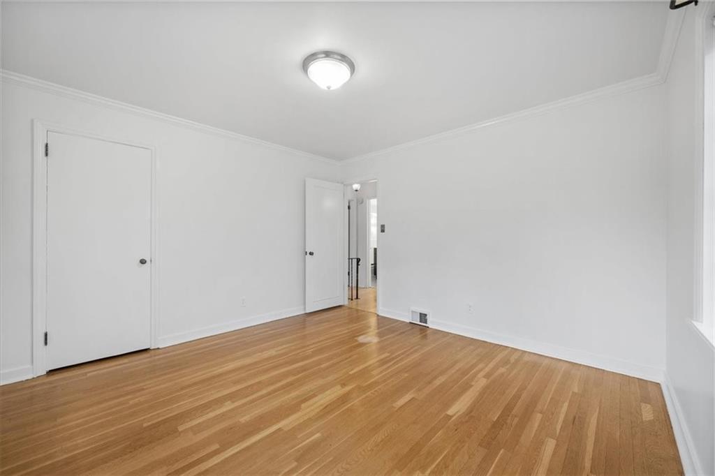 2800 Fernwald Road Pittsburgh, PA 15217 - Photo 22 of 37 a view of an empty room with wooden floor and a window