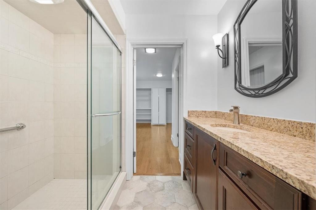 2800 Fernwald Road Pittsburgh, PA 15217 - Photo 25 of 37 a bathroom with a granite countertop sink a mirror and a shower