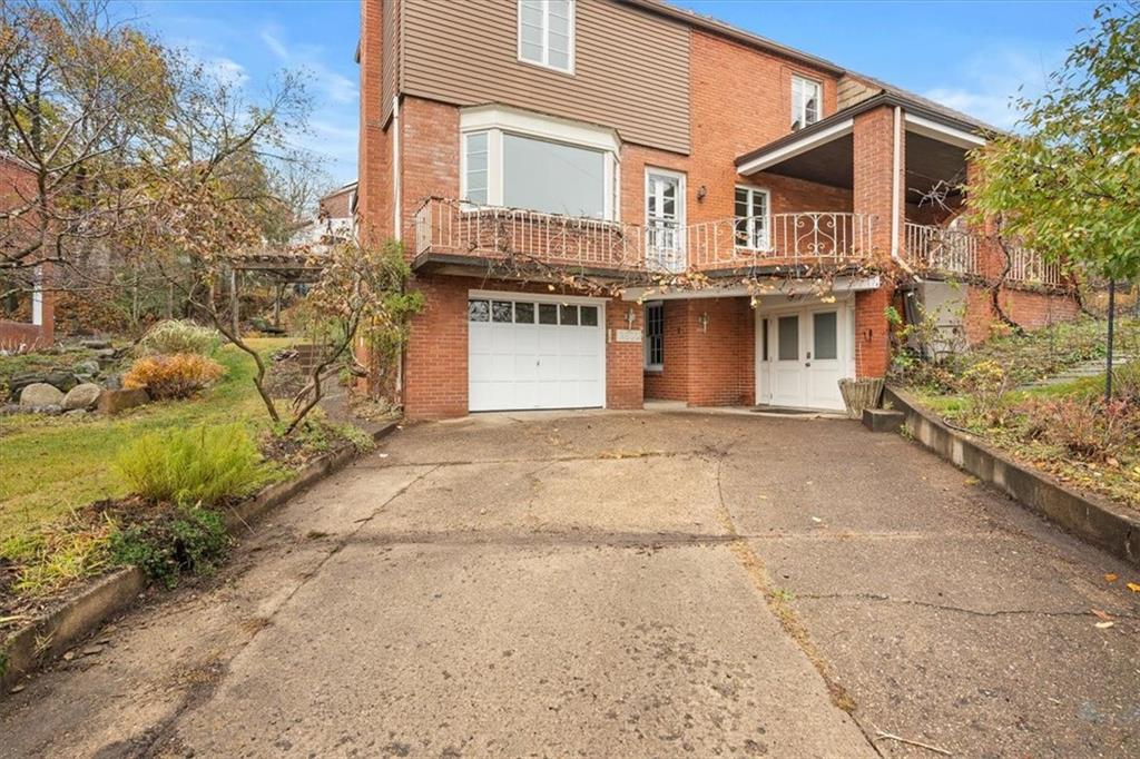 2800 Fernwald Road Pittsburgh, PA 15217 - Photo 35 of 37 a front view of a house with a yard and garage