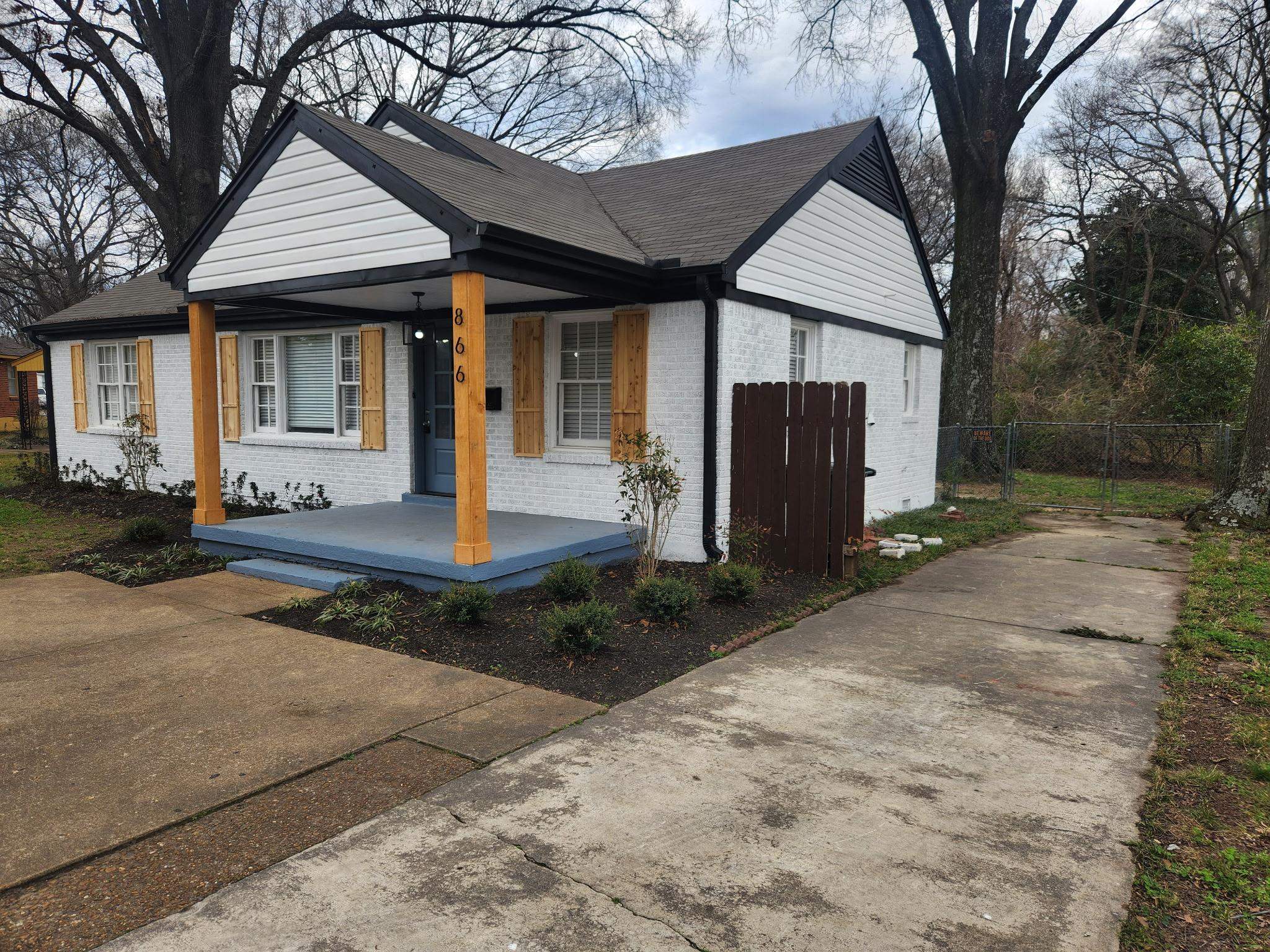 866 Colonial Road Memphis, TN 38117 - Photo 3 of 15 View of front of property featuring brick siding, covered porch, and concrete driveway
